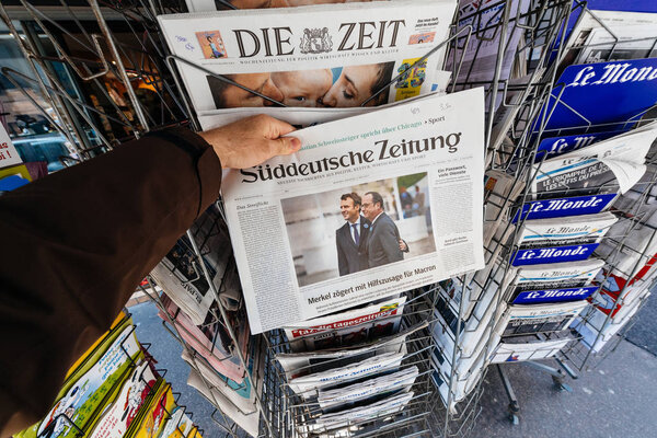 Man buying Suddeutsche Zeitung with the newly elected French pre