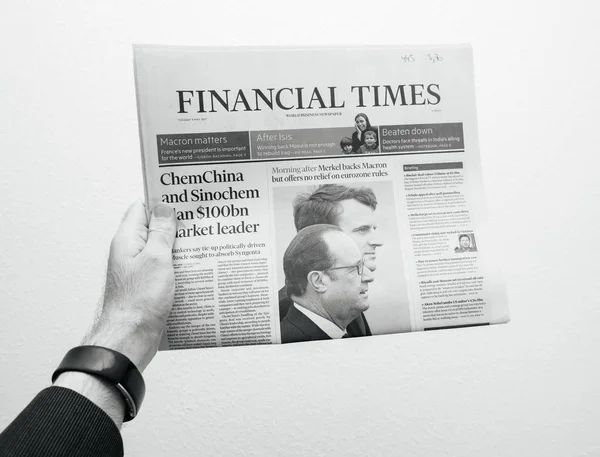 Man holding Financial Times newspaper with Emmanuel Macron on fi — Stock Photo, Image