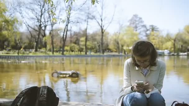 Κομψό Νεαρή Γυναίκα Ψάχνει Στο Smartphone Χρησιμοποιώντας Κοινωνικό Δίκτυο Κοινή — Αρχείο Βίντεο