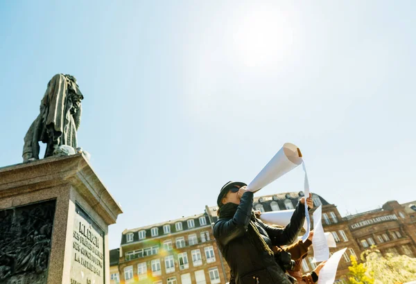 Group of people talking in megaphones at protest — Stock Photo, Image