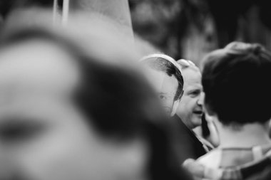 Protesto olarak Emmanuel macron maskesi giyen adam 