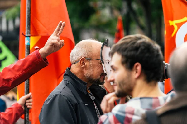 Man wearing Emmanuel macron mask at protest — Stock Photo, Image