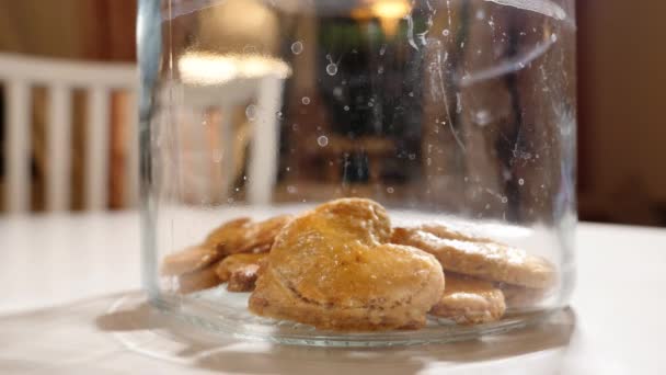 Glass jar with heart shaped biscuits — Stock Video