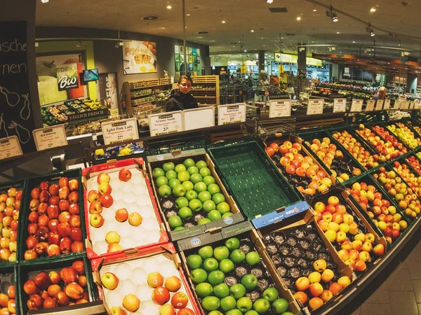 Mujer comprando manzanas variedades en supermercado alemán de la ciudad — Foto de Stock