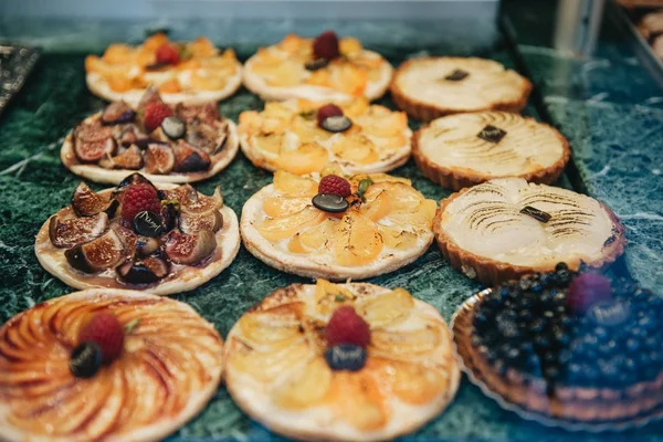 Vitrine at French bakery with delicious desserts for sale — Stock Photo, Image