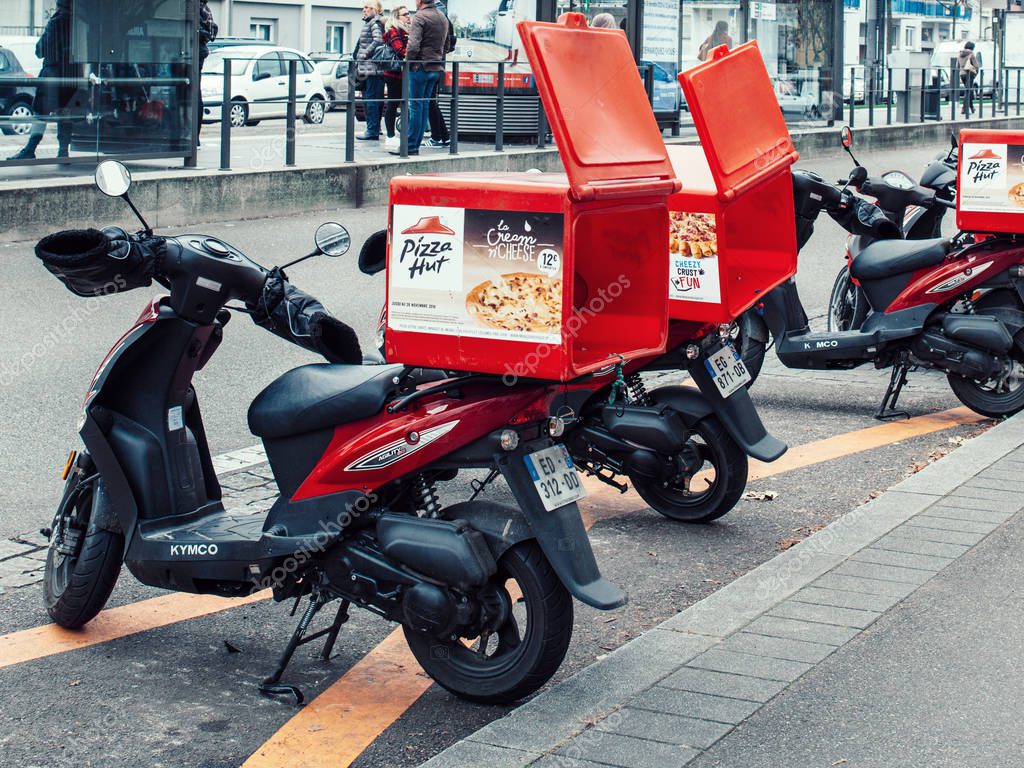 STRASBOURG, FRANCE - DEC 2, 2016: Pizza-Hut delivery motorcycles parked on the street waiting for the order and delivery to the client
