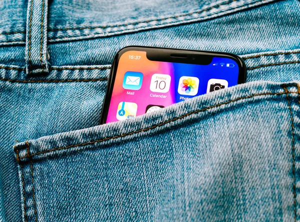 New Apple iPhone X 10 in pocket of denim jeans trousers — Stock Photo, Image