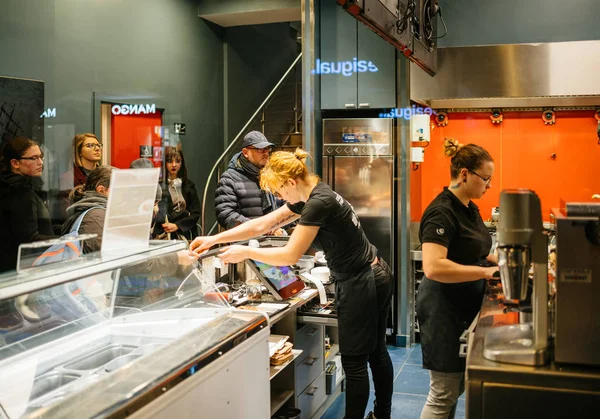 Orkers people inside a waffle making shop, view behind the count — Stock Photo, Image