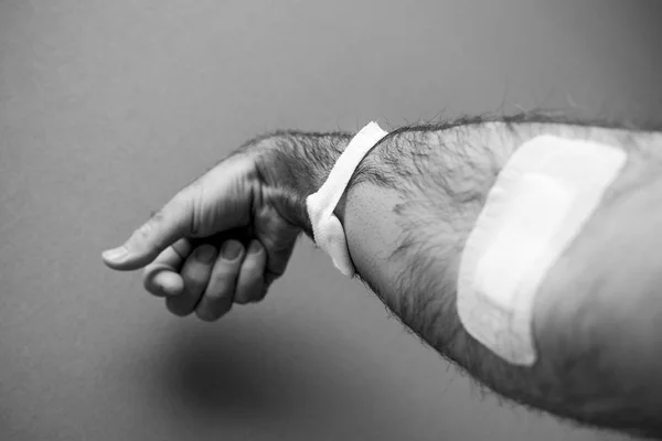 Close-up detail of man hand with adhesive tape after blood trans — Stock Photo, Image