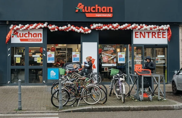 Wejście do ssupermarket francuski Auchan w mieście z ludźmi — Zdjęcie stockowe