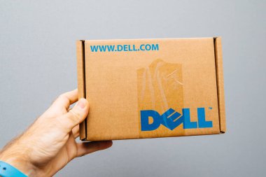 Paris, Fransa - 6 Aralık 2017: Arka planı gri karton kutu içinde Dell bilgisayar logosu yedek parça ile karşı onun için bölüm tutan adam o Servisi