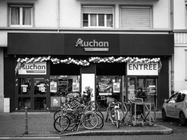 Auchan Supermarket entrance in French neighborhood on a winter s clipart