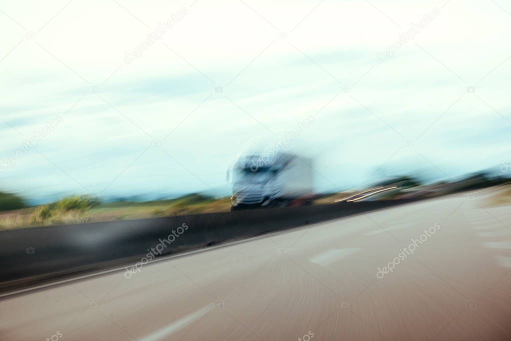 Conceptual silhouette of a defocused truck in motion on highway