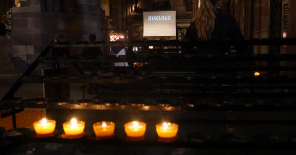 Lighting candle in Strasbourg Cathedral church Notre-Dame — Stock Video