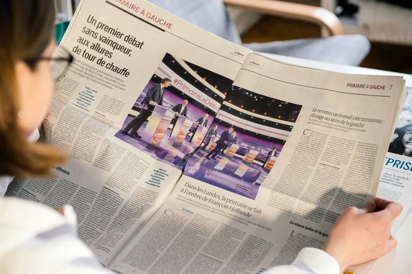 Žena čtení Le Monde noviny s francouzské prezidentské debaty — Stock fotografie