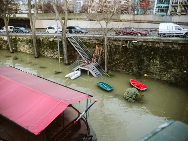 Swollen river Seine with barges and boats