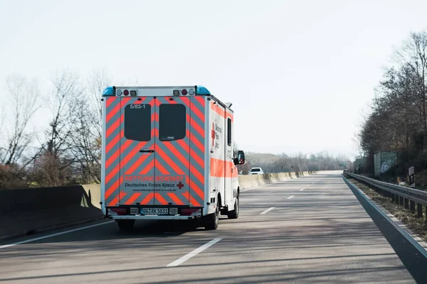 Deutsches Rotes Kreuz ambulance on German rural road — Stock Photo, Image