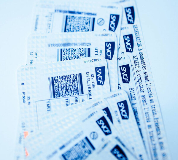 Stack of multiple SNCF train tickets seen from above 