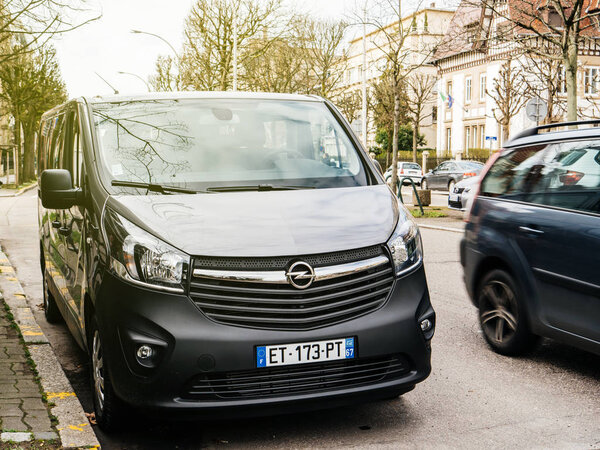 STRASBOURG, FRANCE - CIRCA 2018: Front view of new Opel Vivaro BiTurbo passenger minivan car parked on a French street