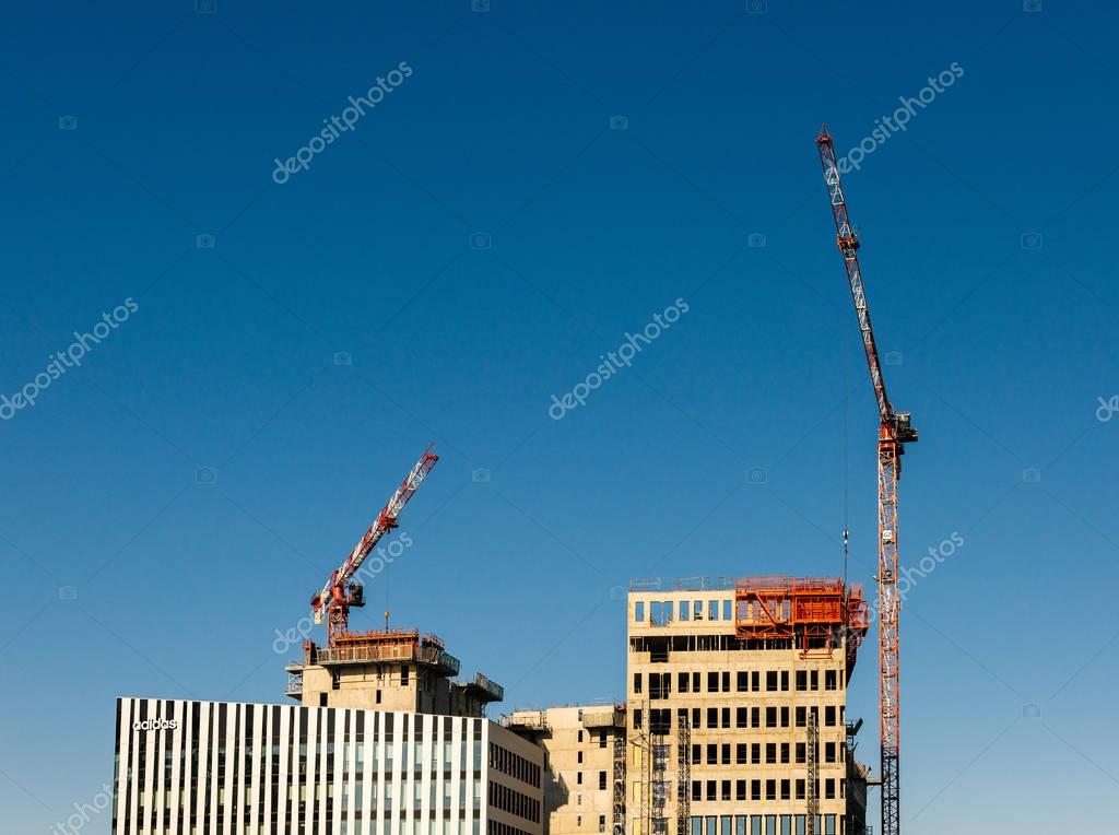 STRASBOURG, FRANCE - APR 6, 2018: Final retouches of the ADIDAS Sportswear Headquarter in Strasbourg with crane working on the nearby construction site in Strasbourg, France