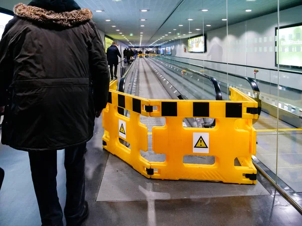 Airport scene with workers from ThyssenKrupp moving walkway — Stock Photo, Image