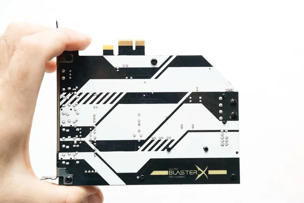 Man hand holding new Creative Sound Blaster Audio card for Pc — Stock fotografie