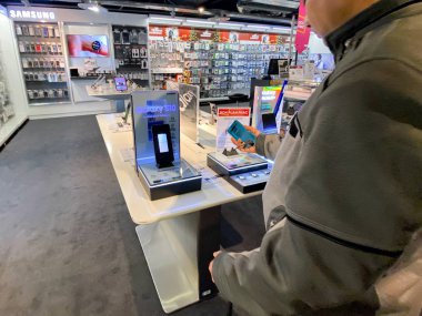 Yetişkin adam Kara Cuma 'dan önce Samsung Galaxy S10 Fnac Fransız elektronik mağazasını test ediyor.