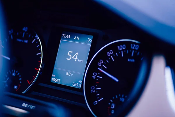 Car driving fast on the street with close-up macro details 54 kilometers per hour signage on the — ストック写真