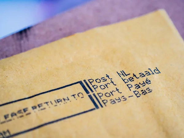 Close-up macro Detail of business envelope from Post NL Netherlands Port Payepostal service with Prioritaire stamp printed on dot matrix printer — Stock Photo, Image