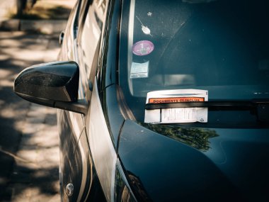 Documents inclus translated as included documents - plastic pouch with parking fine ticket clipart