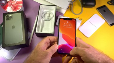 Paris, France - Sep 20, 2019: POV man hand holding after unpacking highly acclaimed new Apple Computers iPhone 11 Pro and 11 Pro Max smartphone triple-lens camera