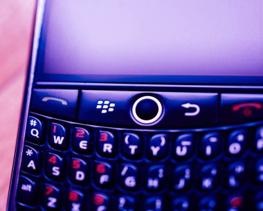 London, United Kingdom - Apr 21, 2013: Macro close-up Tilt-shift lens used on Blackberry Palm vintage smartphones telephone manufactured by defunct Blackberry with full qwerty keyboard