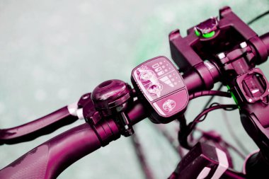 Detail of the steering wheel of a modern electric bicycle with speed controller, battery