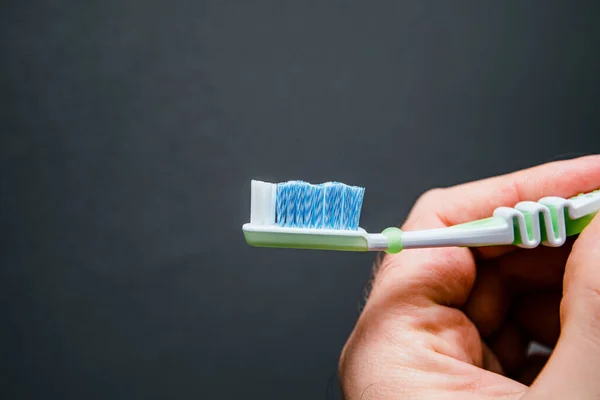 Close Male Hand Holding New Toothbrush Gray Background — Stock Photo, Image