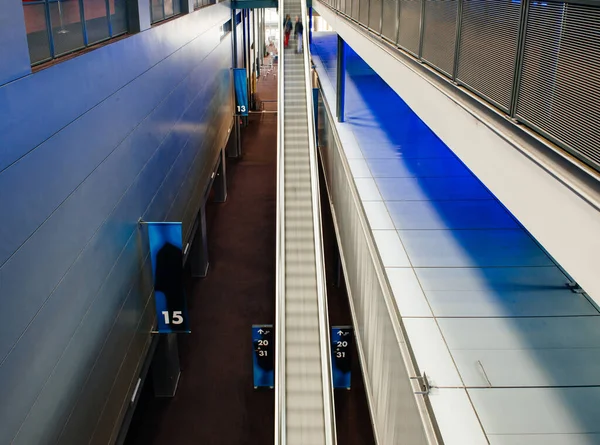 Vista de silhuetas de pessoas que ascendem nas escadas rolantes rápidas dentro do grande cinema — Fotografia de Stock