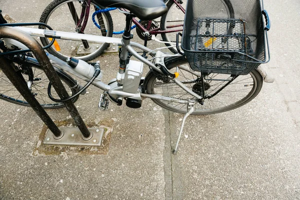 Modern electric powered bicycle parked near the steel — Stock Photo, Image