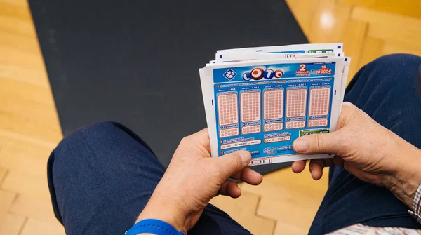 Overhead view of senior male hands holding Loto tickets from the FDJ French lottery system — Stock Photo, Image