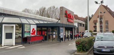 Robertsau 'daki Fransız Auchan süpermarketinde Coronavirus kuyruğunda insanlar var.