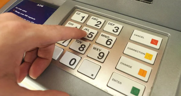 ATM machine and close-up man hand. — Stock Photo, Image