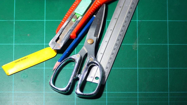 Scissor and cutter and ruler and pencil and blades. — Stock Photo, Image