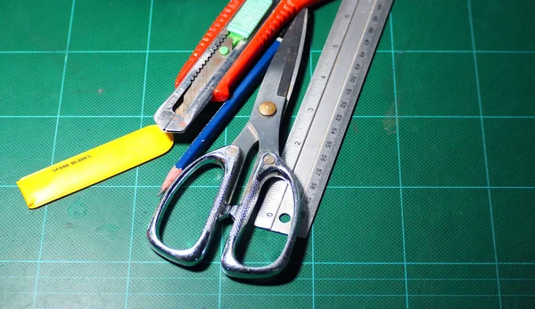 Scissor and cutter and ruler and pencil and blades. — Stock Photo, Image