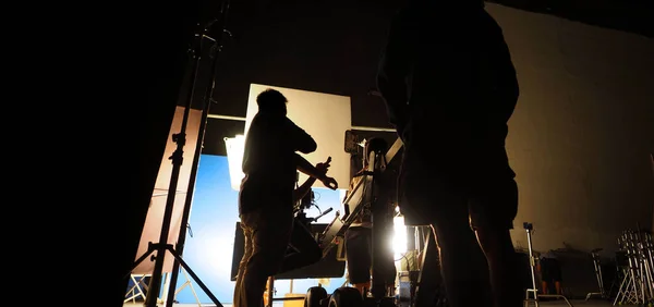 Behind the scenes of video or movie production in big studio and blue screen technique or chroma key shooting and film crew team with pro equipment such as crane dolly which big scale for commercial industry — Stock Photo, Image