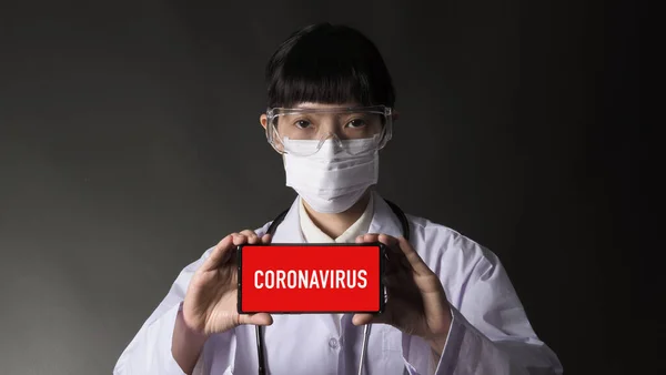 Asian young woman doctor with virus protector N95 mask in studio black background which represent about coronavirus outbreak that pandemic in Wuhan district of China and many people infected.