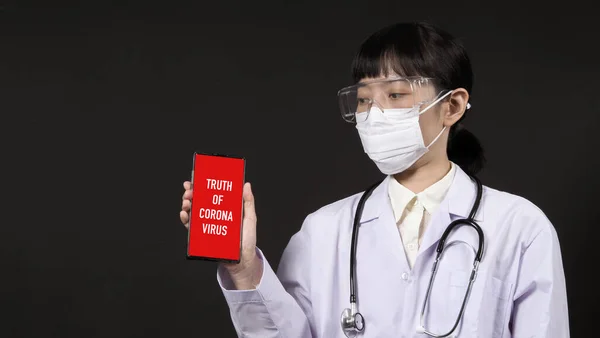 Asian young woman doctor with virus protector N95 mask in studio black background which represent about coronavirus outbreak that pandemic in Wuhan district of China and many people infected.