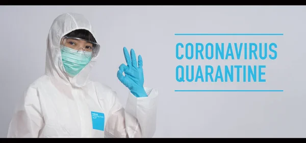 Asian doctor woman wear PPE suit or Personal Protective Equipment and medical mask and gloves which use for protect covid-19 virus pandemic from Wuhan China and talking about quarantine for safety