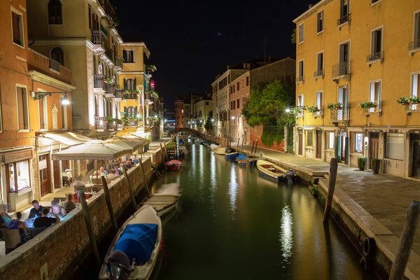 Beautiful photo of Venice at night. Light from the lanterns erupts in the canals of Venice