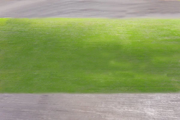 Aerial view Rows of soil before planting.Furrows row pattern in a plowed field prepared for planting crops in spring.Horizontal view in perspective. — Stock Photo, Image