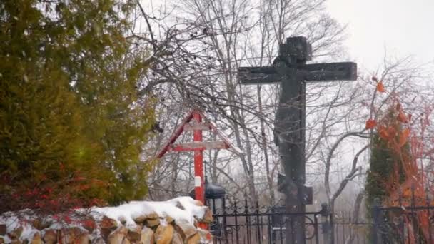 Кладбищный крест, покрытый снегом в зимний сезон — стоковое видео