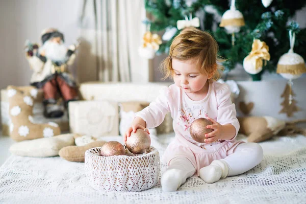 Adorable little girl by the Christmas tree — Stock Photo, Image