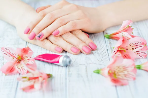 Hands with pink color nails manicure